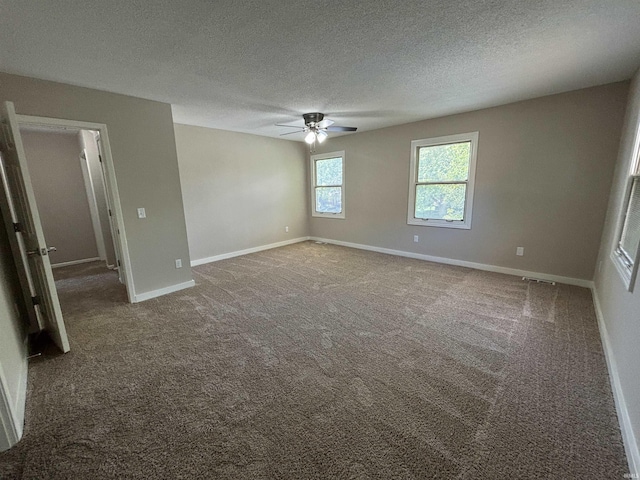 carpeted spare room featuring ceiling fan and a textured ceiling