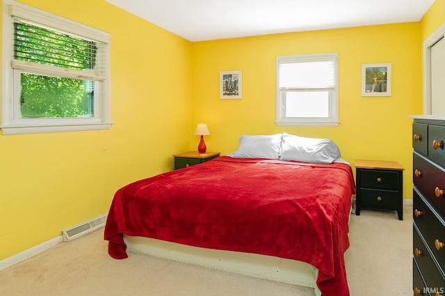 bedroom featuring light carpet