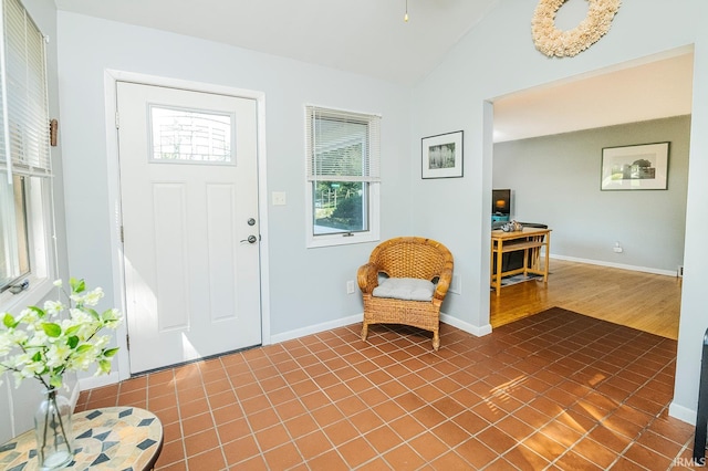 tiled foyer entrance with lofted ceiling