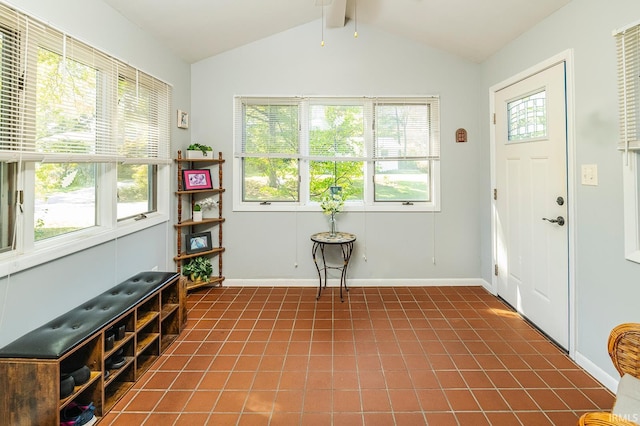 tiled foyer with lofted ceiling with beams and a healthy amount of sunlight