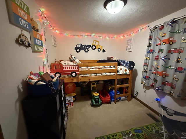 bedroom with carpet floors and a textured ceiling