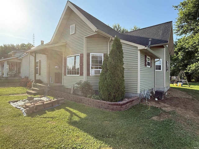 1705 E Main St, Petersburg, IN 47567 - view of side of property featuring a yard and roof with shingles