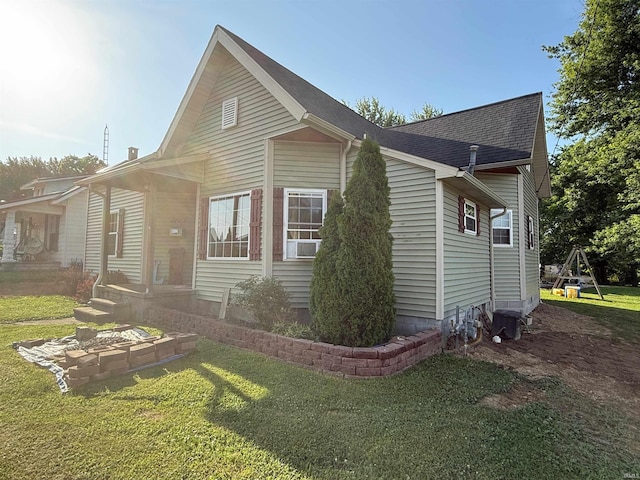 1705 E Main St, Petersburg, IN 47567 - view of side of home featuring a lawn and a shingled roof