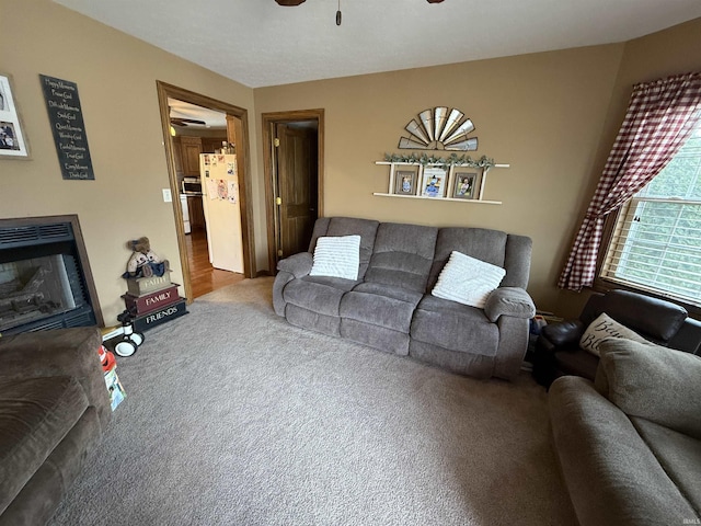 living room with carpet floors and ceiling fan