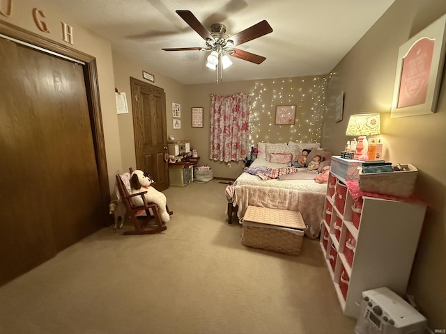 carpeted bedroom with ceiling fan and a closet