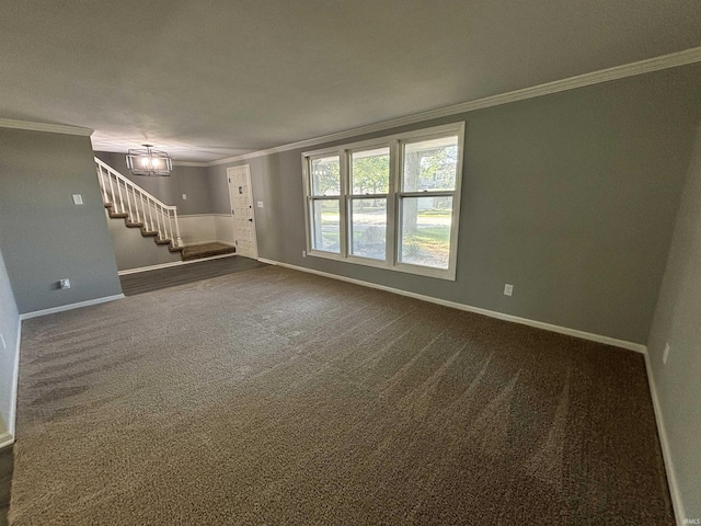 unfurnished living room featuring a notable chandelier, ornamental molding, and dark colored carpet