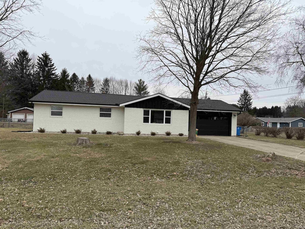 ranch-style house with a garage and a front lawn