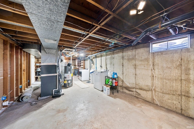 basement with water heater and washing machine and dryer