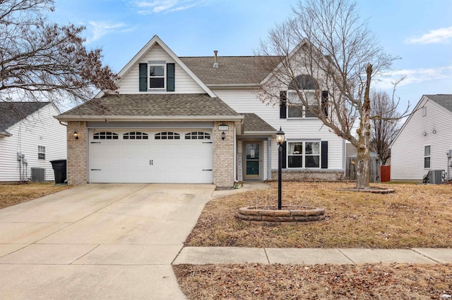 view of front property featuring a garage and cooling unit