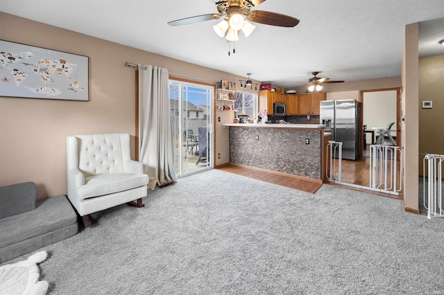 living room with ceiling fan and light carpet