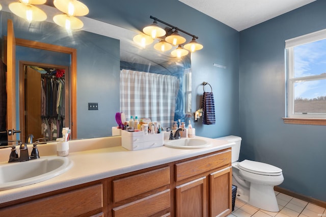 bathroom with vanity, tile patterned flooring, toilet, and an inviting chandelier