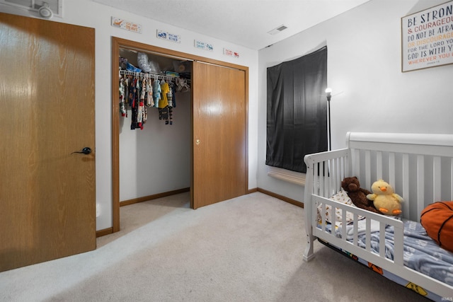 bedroom with light carpet and a closet