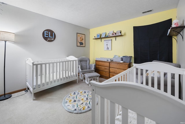 bedroom with a textured ceiling and carpet flooring