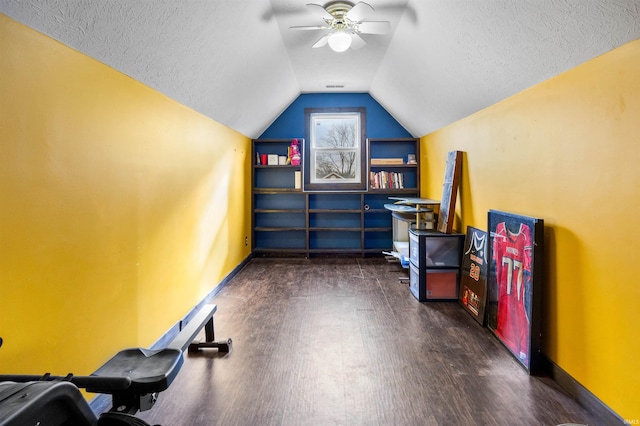 bonus room with lofted ceiling, ceiling fan, dark hardwood / wood-style floors, and a textured ceiling