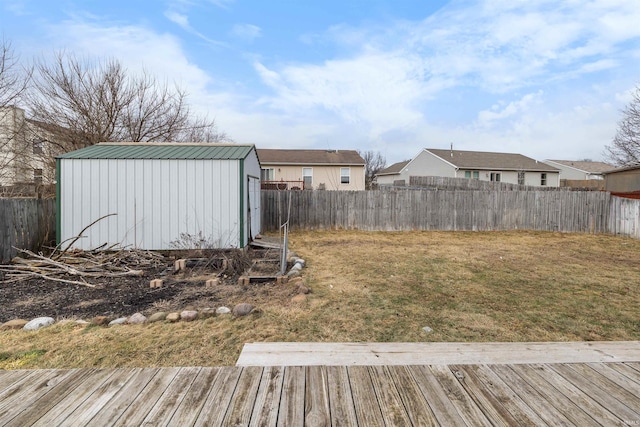 view of yard featuring a deck and a storage shed