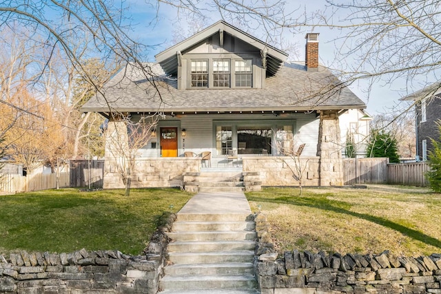 view of front of property with covered porch and a front lawn