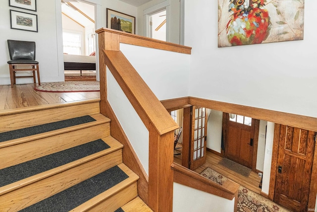 stairs with hardwood / wood-style floors