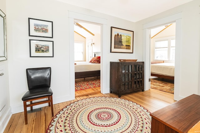 living area featuring plenty of natural light and light hardwood / wood-style floors