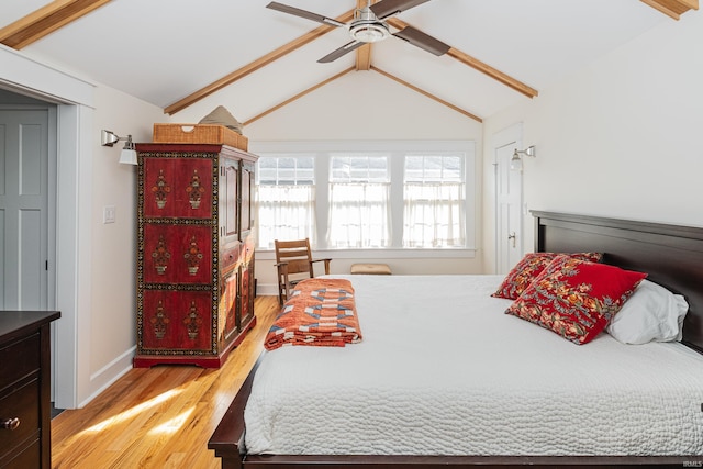 bedroom with vaulted ceiling with beams, ceiling fan, and light hardwood / wood-style flooring