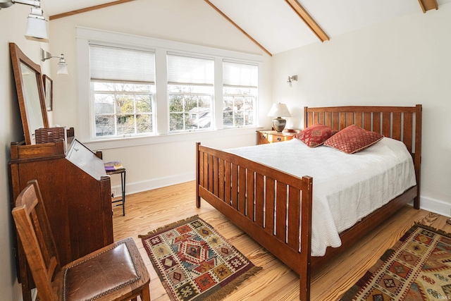 bedroom featuring vaulted ceiling and light hardwood / wood-style floors