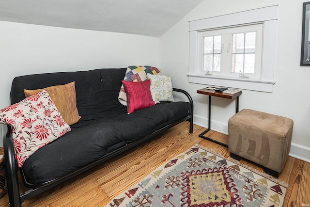 living room featuring lofted ceiling and wood-type flooring