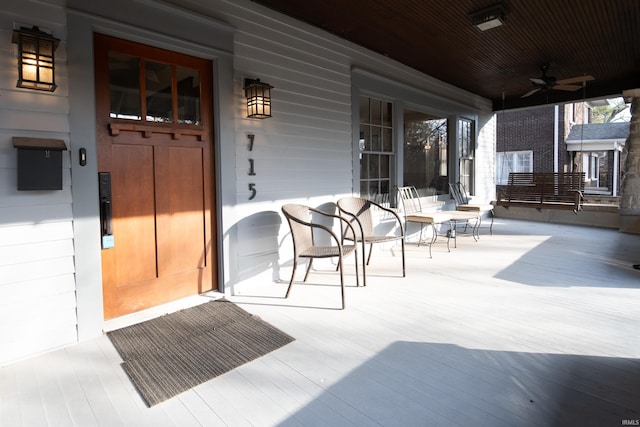 entrance to property featuring ceiling fan and covered porch