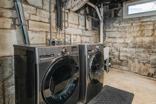 clothes washing area with washer and dryer