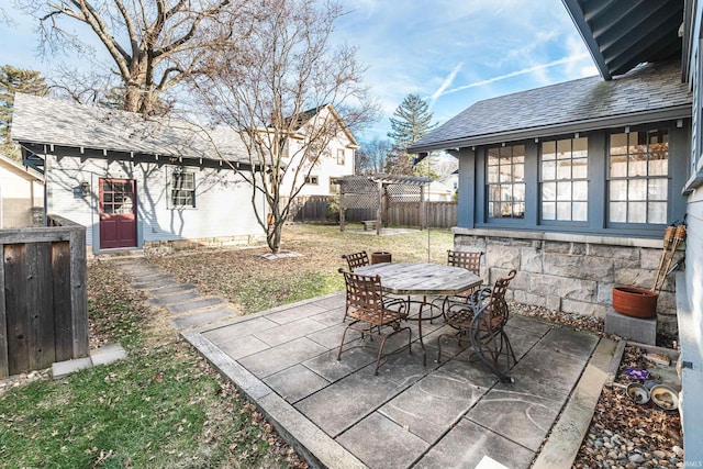 view of patio featuring an outbuilding