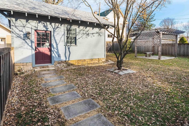 property entrance featuring a pergola and a patio area