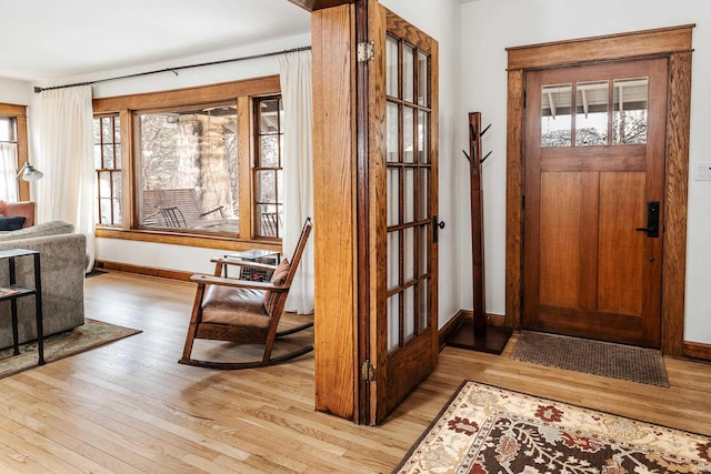 foyer featuring plenty of natural light and light hardwood / wood-style flooring