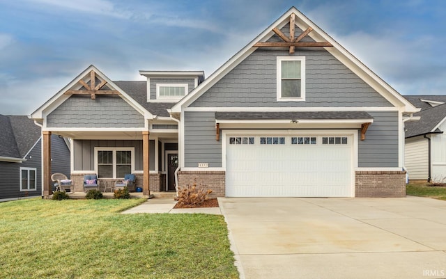 craftsman-style house featuring a garage, a front lawn, and covered porch