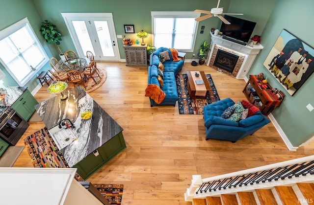 living room with ceiling fan and light wood-type flooring