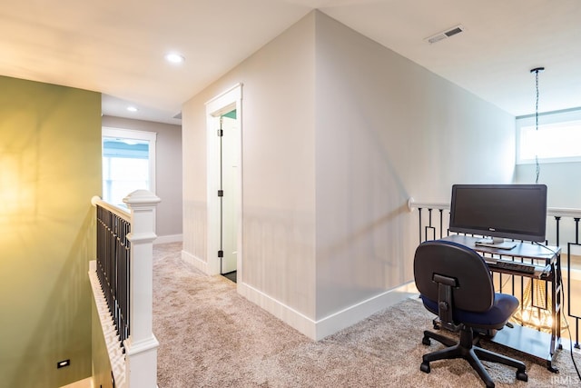 office featuring a healthy amount of sunlight and light colored carpet