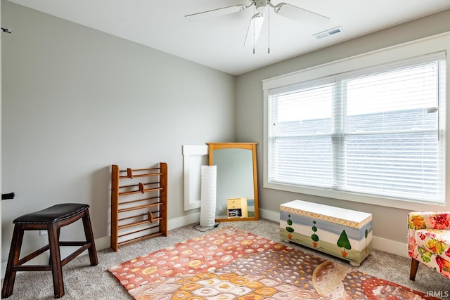 interior space with light colored carpet and ceiling fan