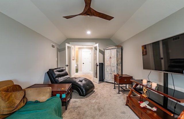 carpeted living room featuring vaulted ceiling and ceiling fan