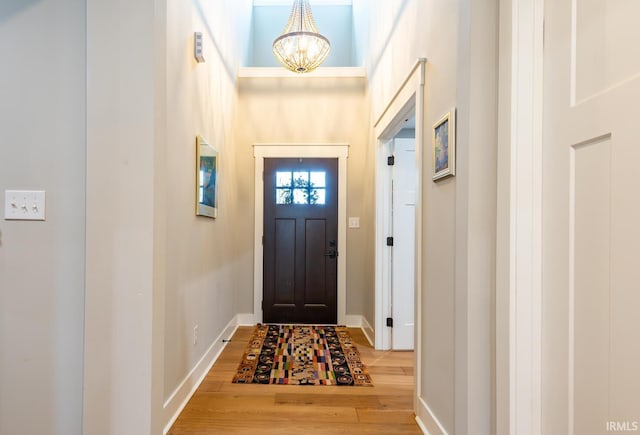 entryway with a notable chandelier and hardwood / wood-style floors