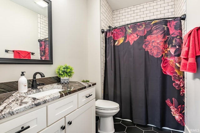 bathroom featuring a shower with curtain, tile patterned floors, toilet, and vanity