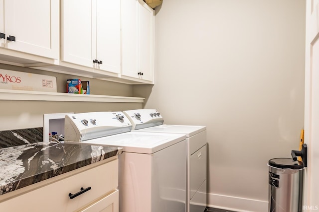 laundry area featuring independent washer and dryer and cabinets