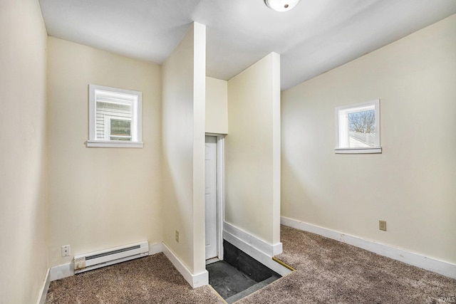 interior space featuring a baseboard heating unit and carpet flooring