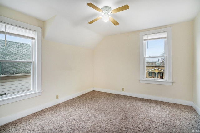 additional living space with lofted ceiling, carpet flooring, and ceiling fan