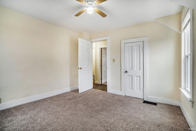 unfurnished bedroom with ceiling fan, carpet flooring, and a closet