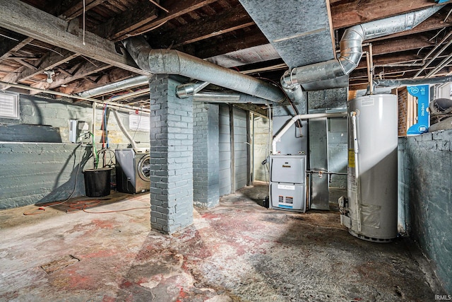 basement featuring heating unit, separate washer and dryer, and water heater