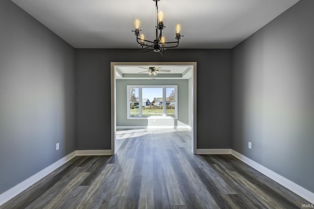 unfurnished dining area with dark wood-type flooring and an inviting chandelier