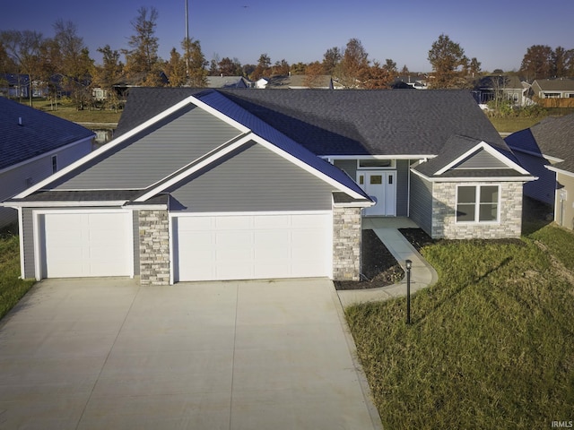 craftsman-style home with a garage and a front lawn