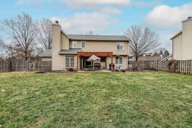 rear view of property with a patio, a yard, and a pergola