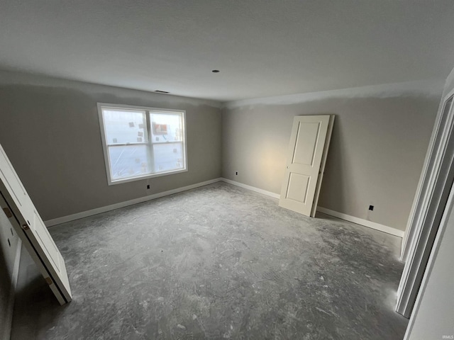 spare room with concrete flooring