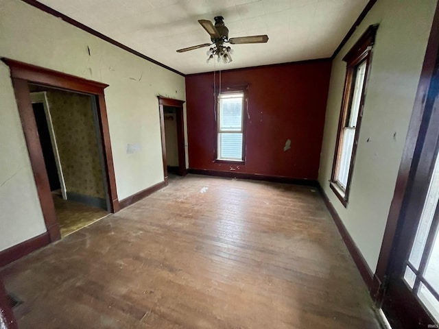 unfurnished bedroom featuring crown molding, ceiling fan, and wood-type flooring