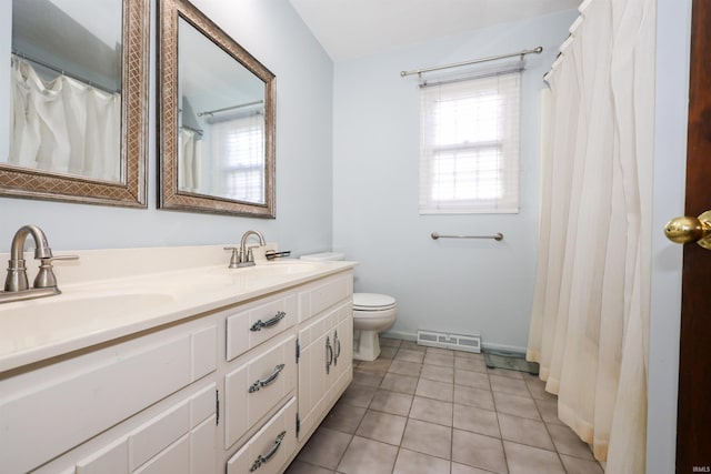 bathroom with vanity, tile patterned floors, and toilet