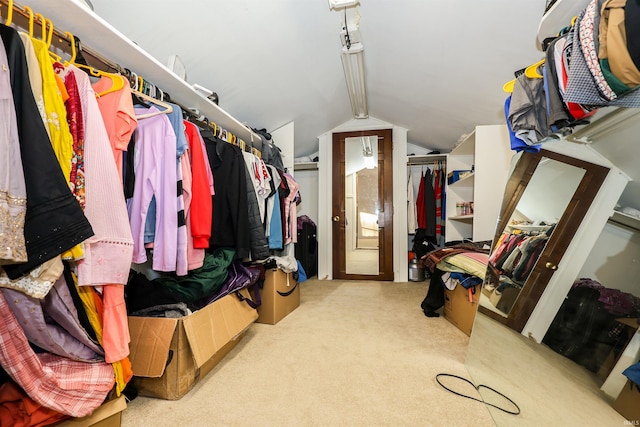 spacious closet featuring vaulted ceiling and light colored carpet