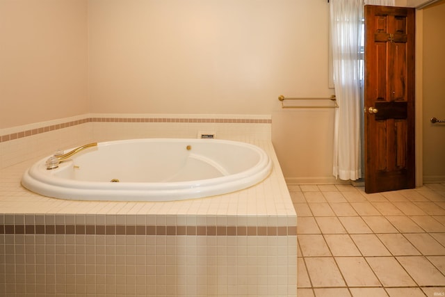 bathroom featuring tiled tub and tile patterned floors